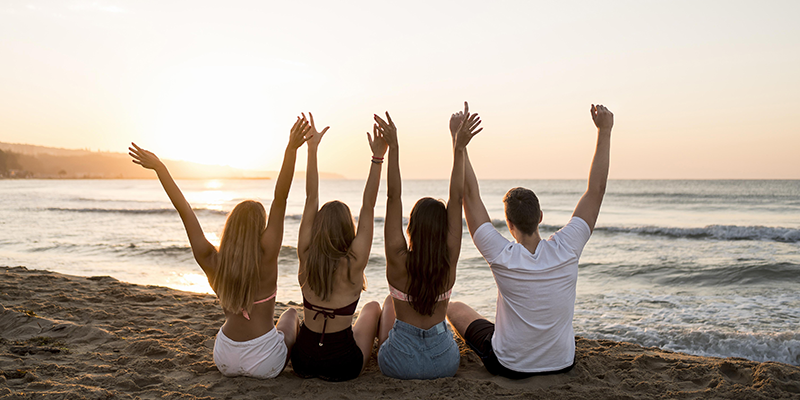 Back view friends holding hands up